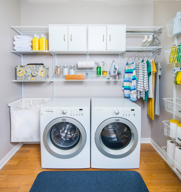 freedomRail laundry room with washer and dryer unit, shelves with detergent and neutral walls.