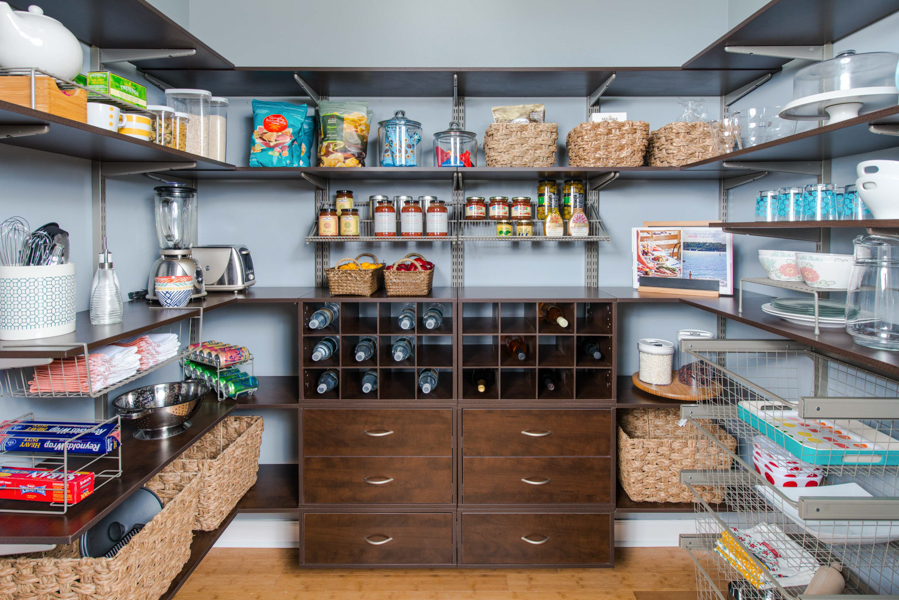freedomRail Walk-In Pantry in Chocolate Pear with baskets, canned food items, dishes with blue walls.