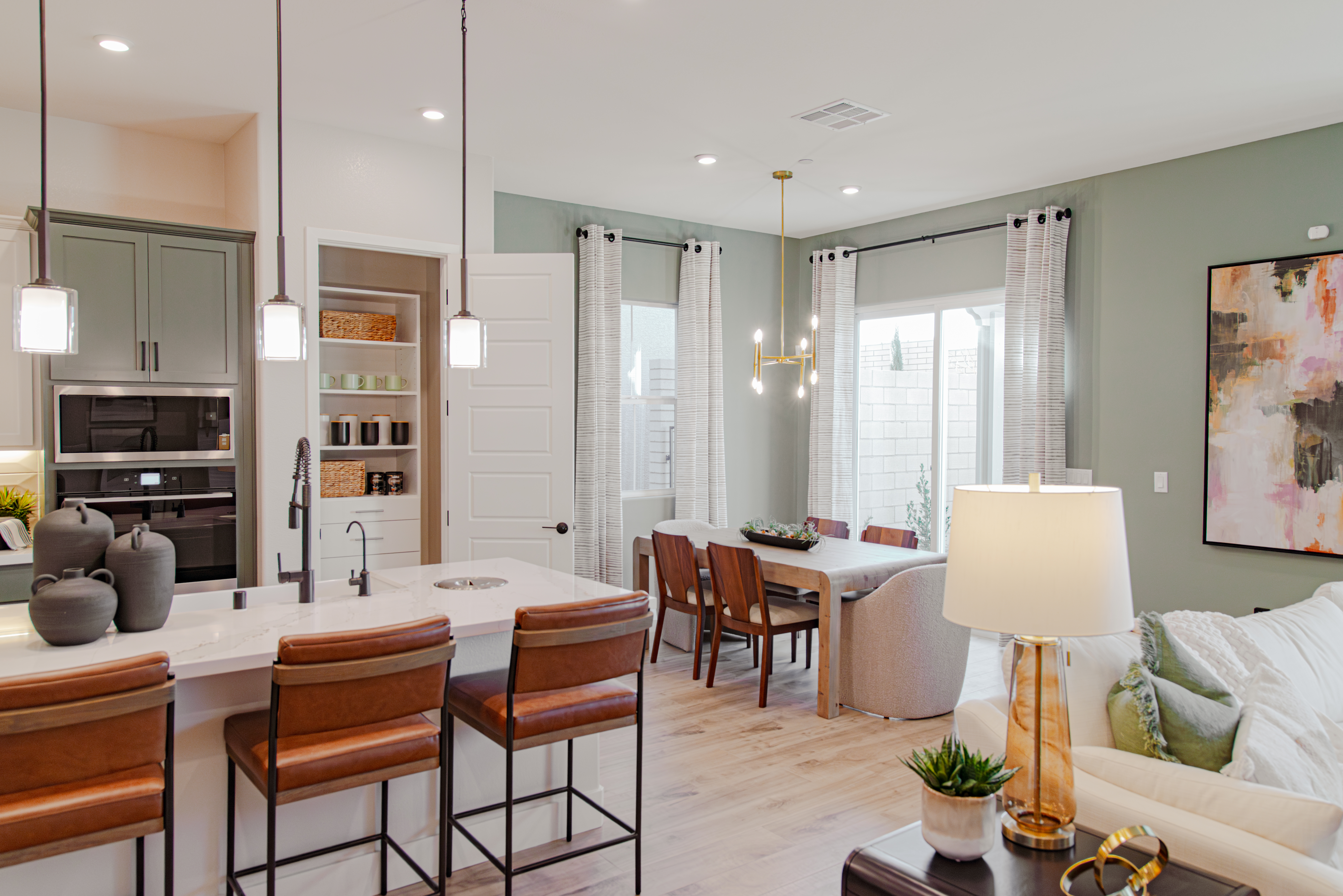 Beazer Vision House - Select Reach-in Pantry in White with overview of kitchen, green accents, and brown tones.