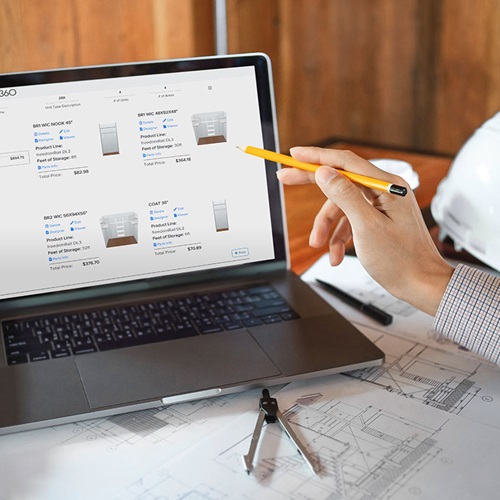 Bid360 on laptop with person using a pencil to point at the laptop screen.