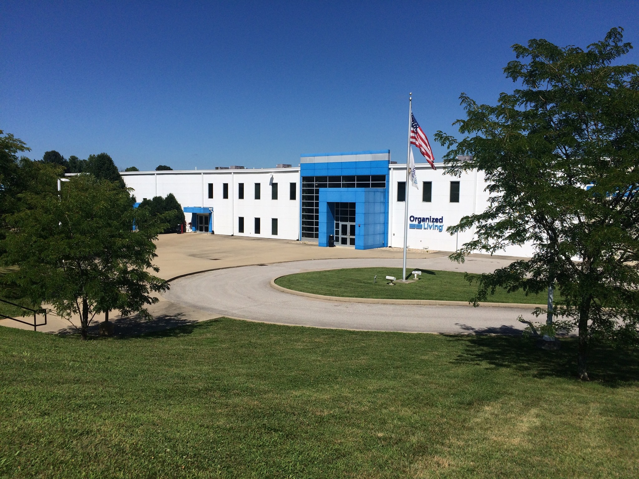 Bloomington plant with landscape and flag pole.