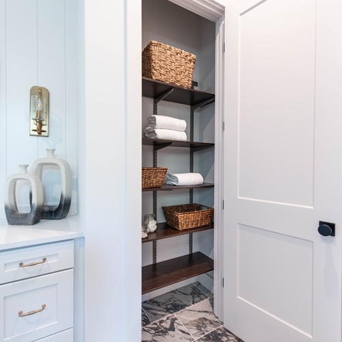 Cincinnati Homearama Primary Bathroom with freedomRail linen and walk-in closet.