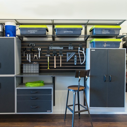 freedomRail Garage with cabinets, sports balls, and work bench.