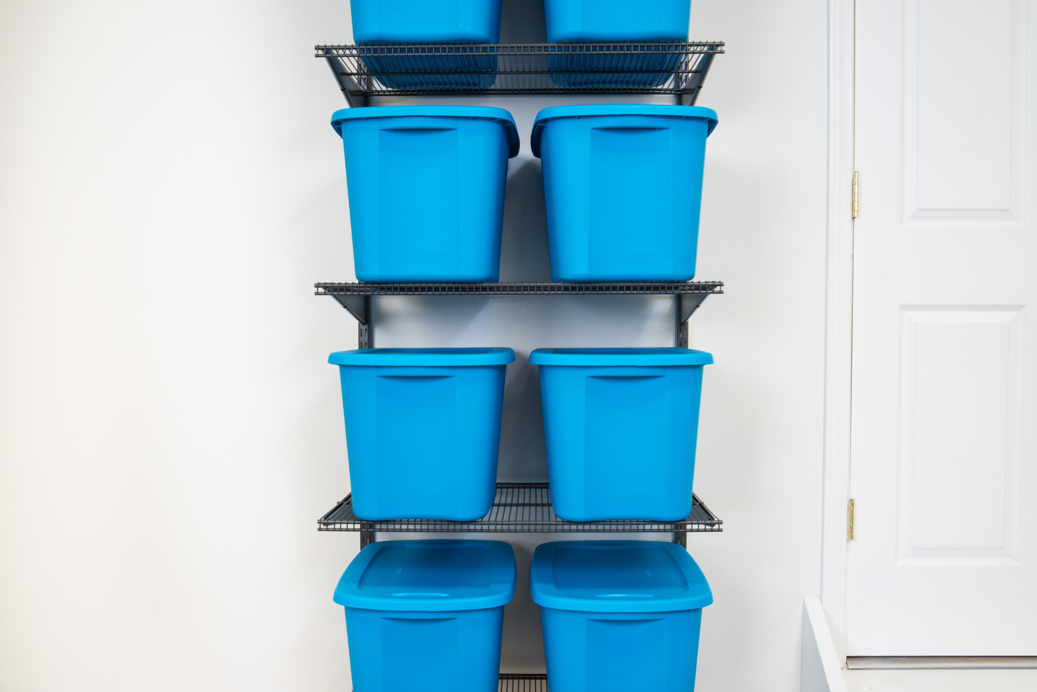 freedomRail Garage in Nickel with blue storage bins stacked.