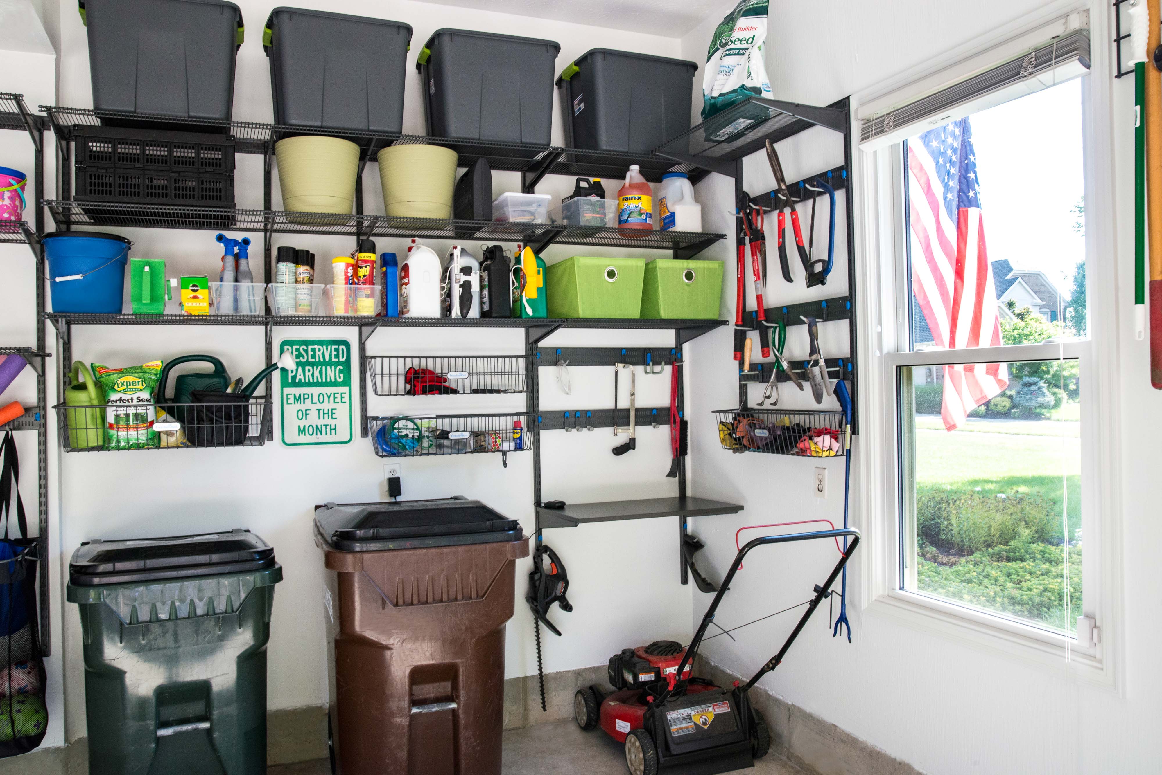 freedomRail Garage Shelves in Nickel with trash cans, storage bins stored high, and other garage items.