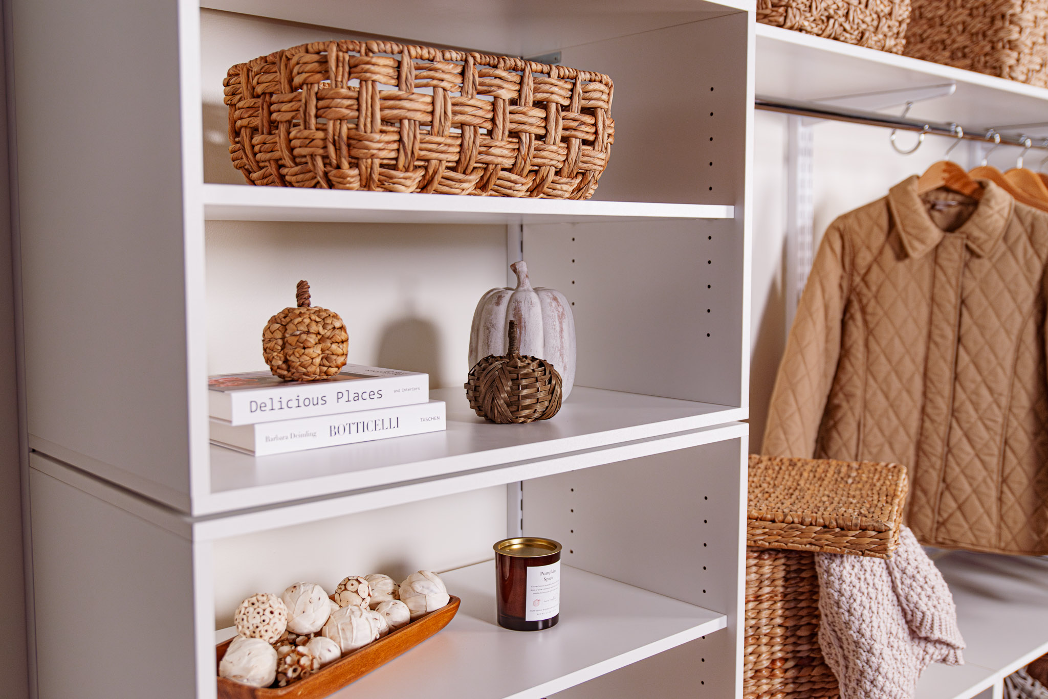 freedomRail Mudroom Close Up in White with fall decor, pumpkins, and neutral clothing.