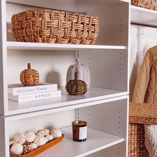 freedomRail Mudroom Close Up in White with fall decor, pumpkins, and neutral clothing.