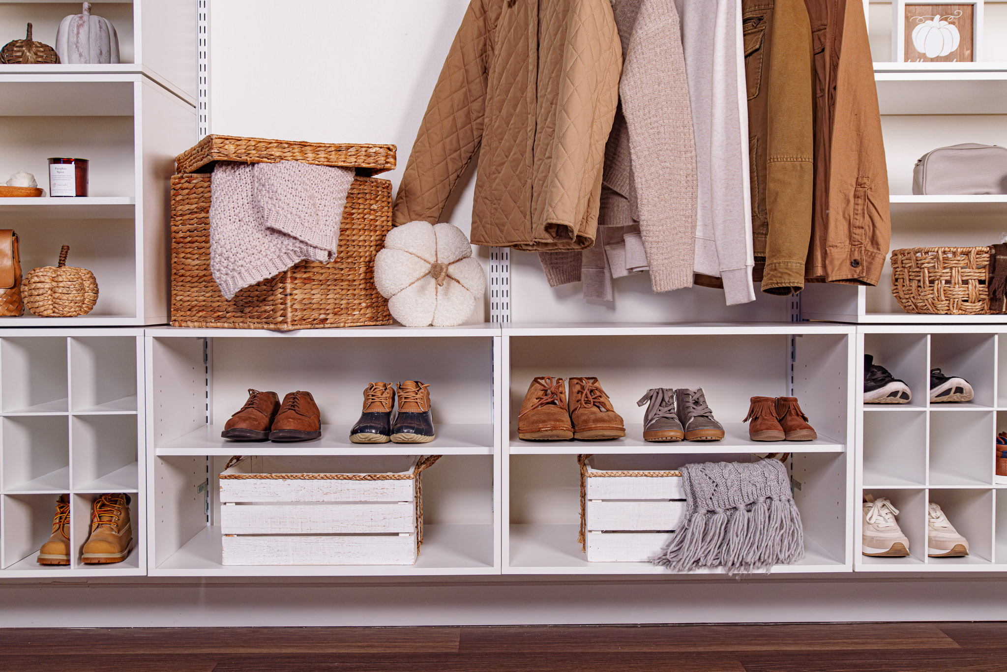 freedomRail Mudroom in White with fall decor, brown neutral toned clothing and accessories.