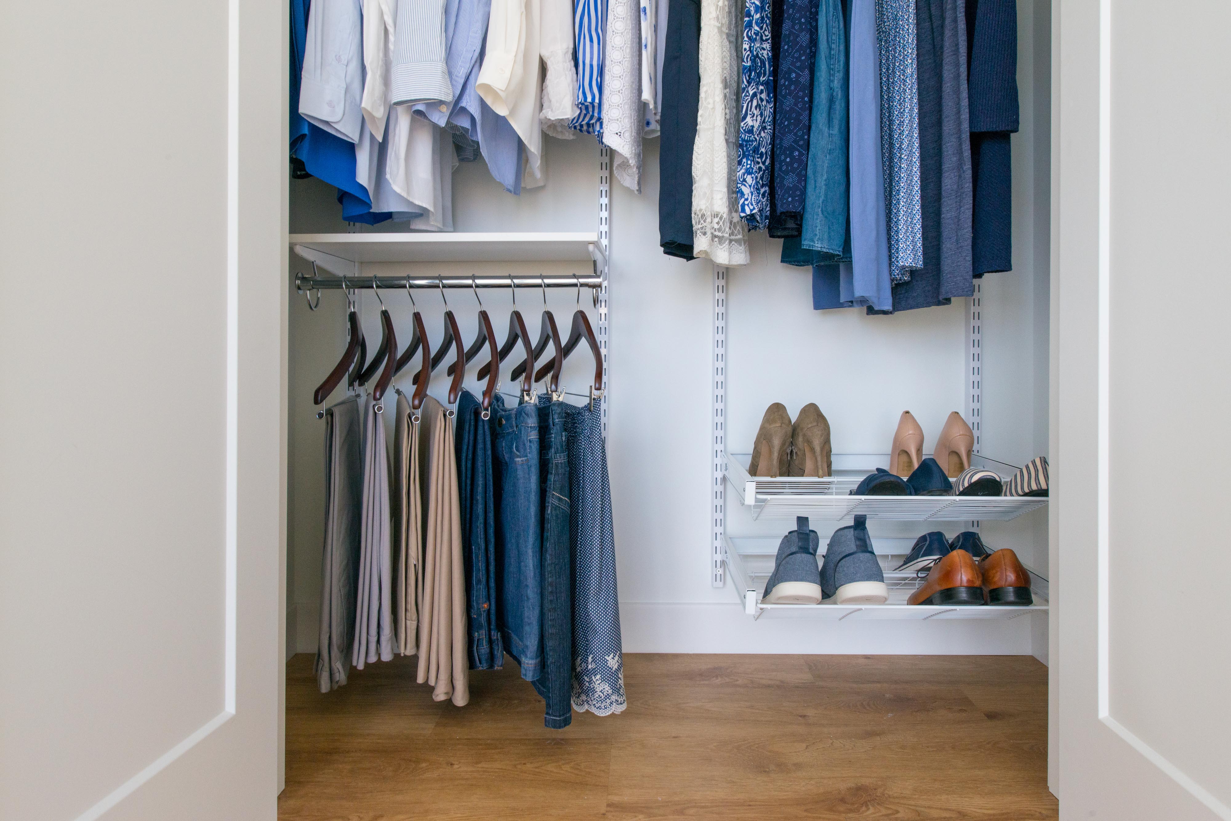 freedomRail Reach-in Closet in White with blue men and women shirts, dresses, bottoms, and shoes.