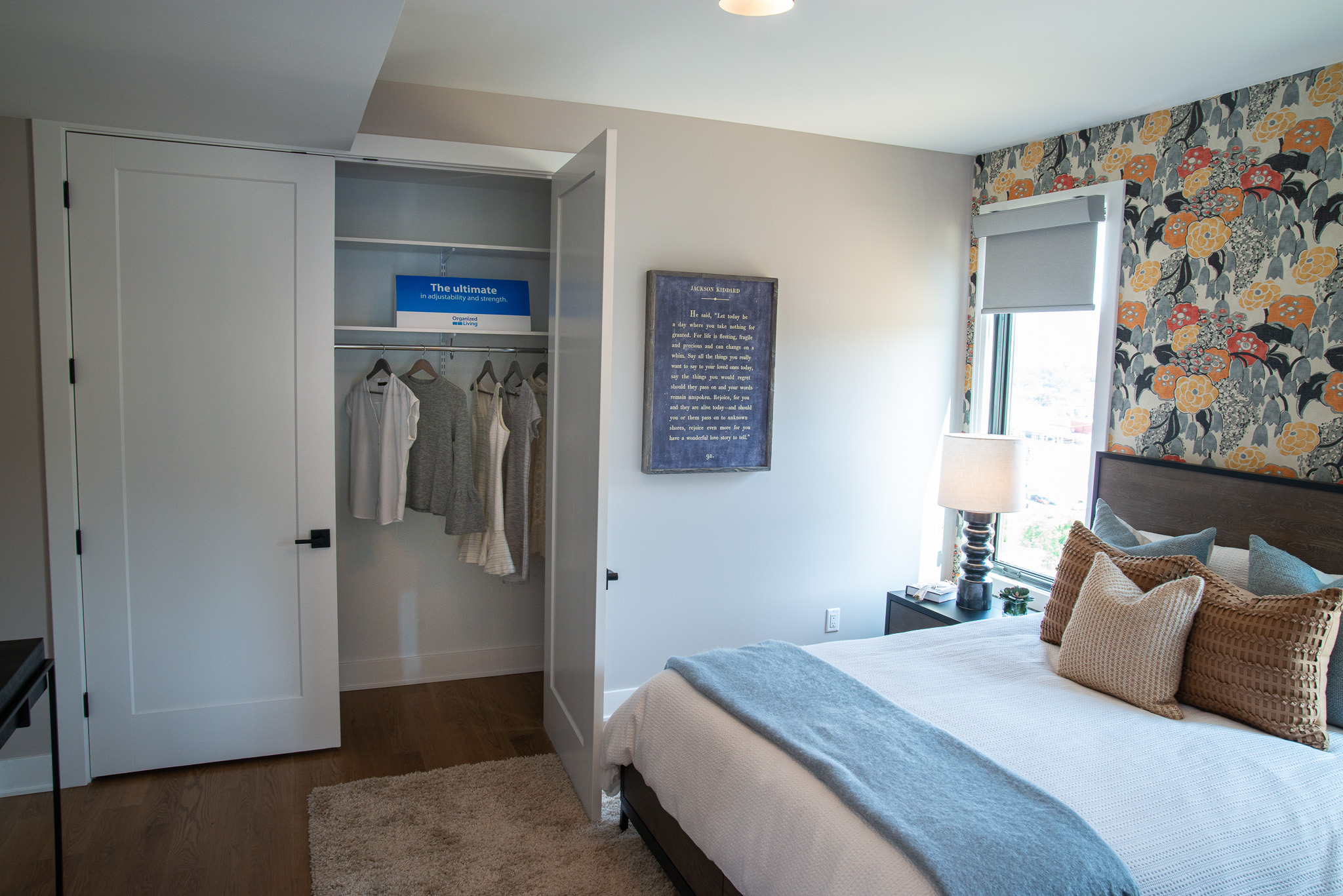 freedomRail Reach-in Closet in White with women's neutral shirts and dresses.