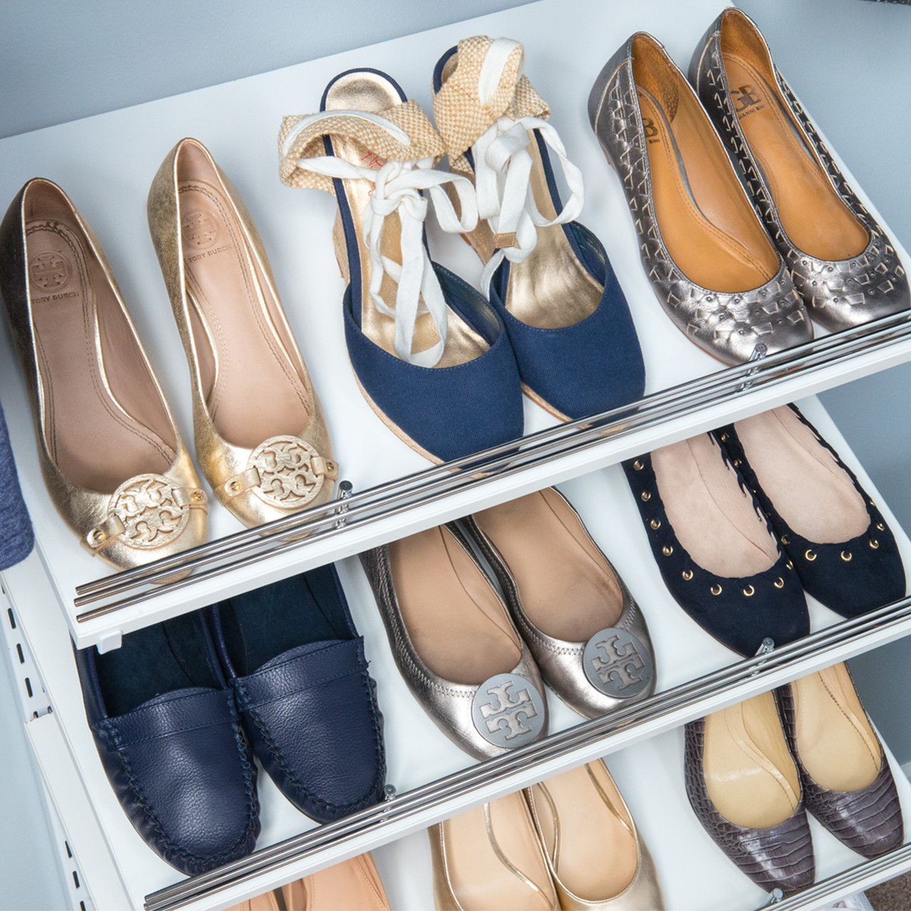freedomRail Shoe Shelf in White with 9 pairs of women's shoes.
