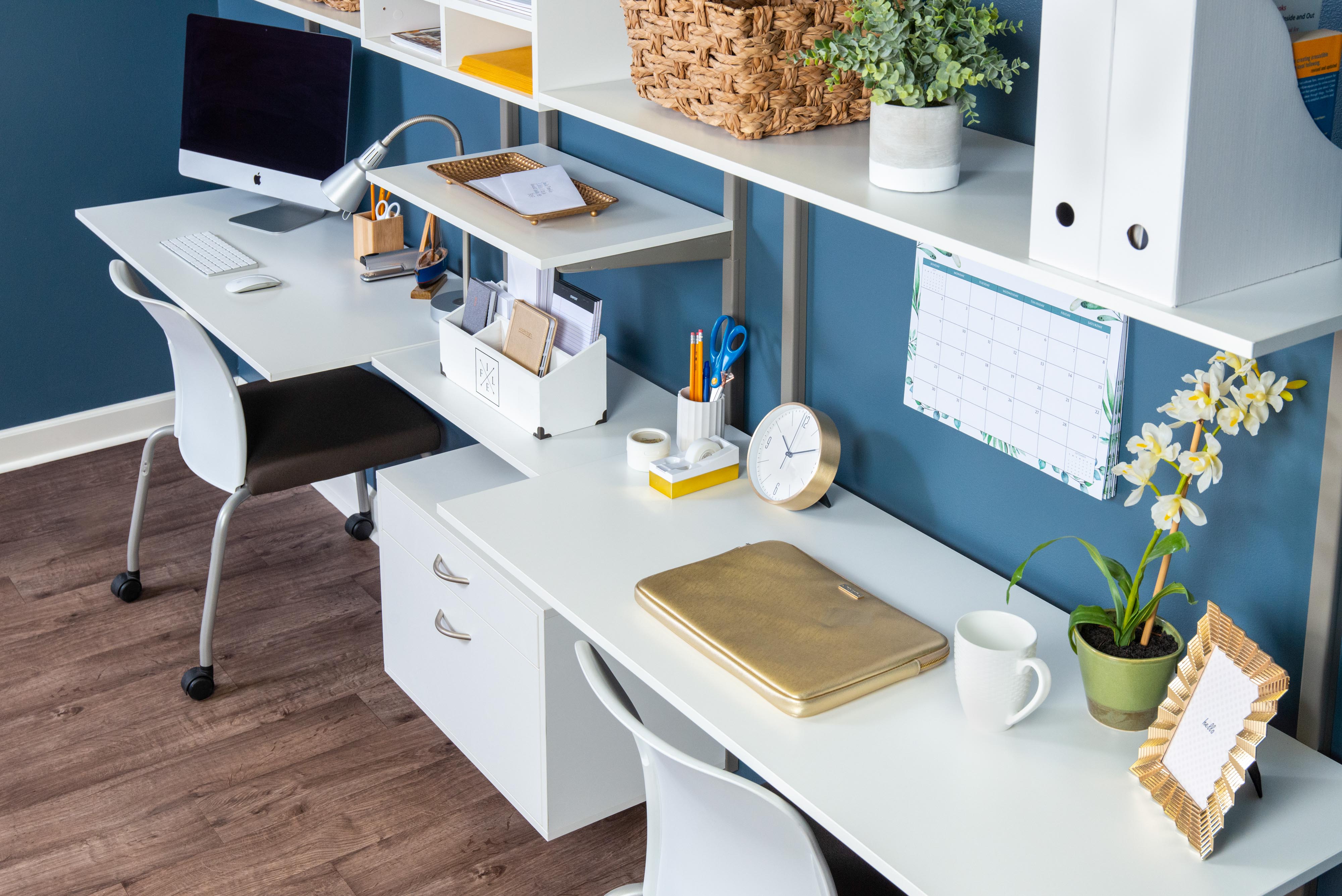 freedomRail White Dual Desk Office with 2 desk chairs, desktop, and office supplies.