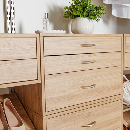 freedomRail_Bedroom_BlondeOak Close Up of drawer boxes with jewelry, plant, shoes and neutral background.