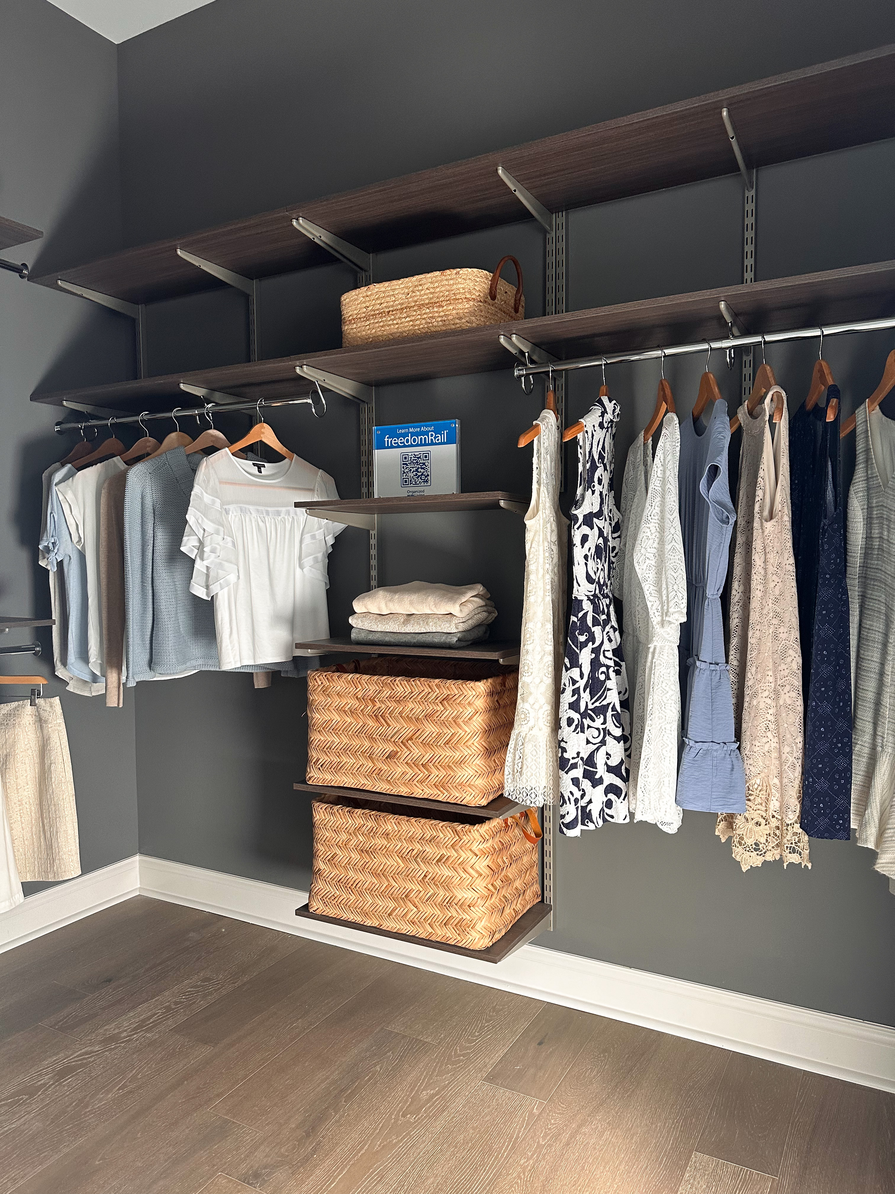 Homearama 2024 freedomRail Closet with women's clothing, baskets, and shelves.