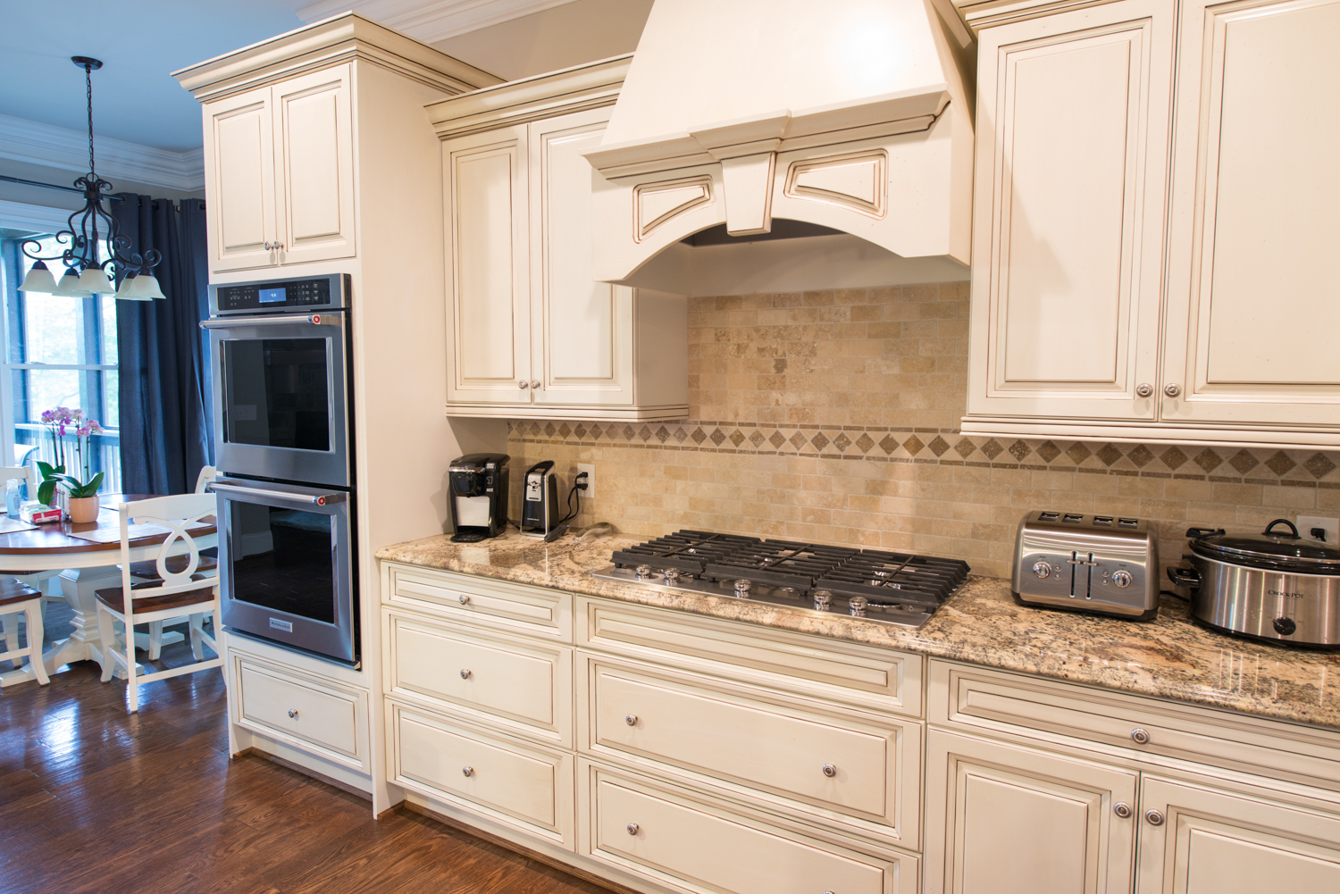 Kitchen counter tops with double oven, and small appliances on counter top.