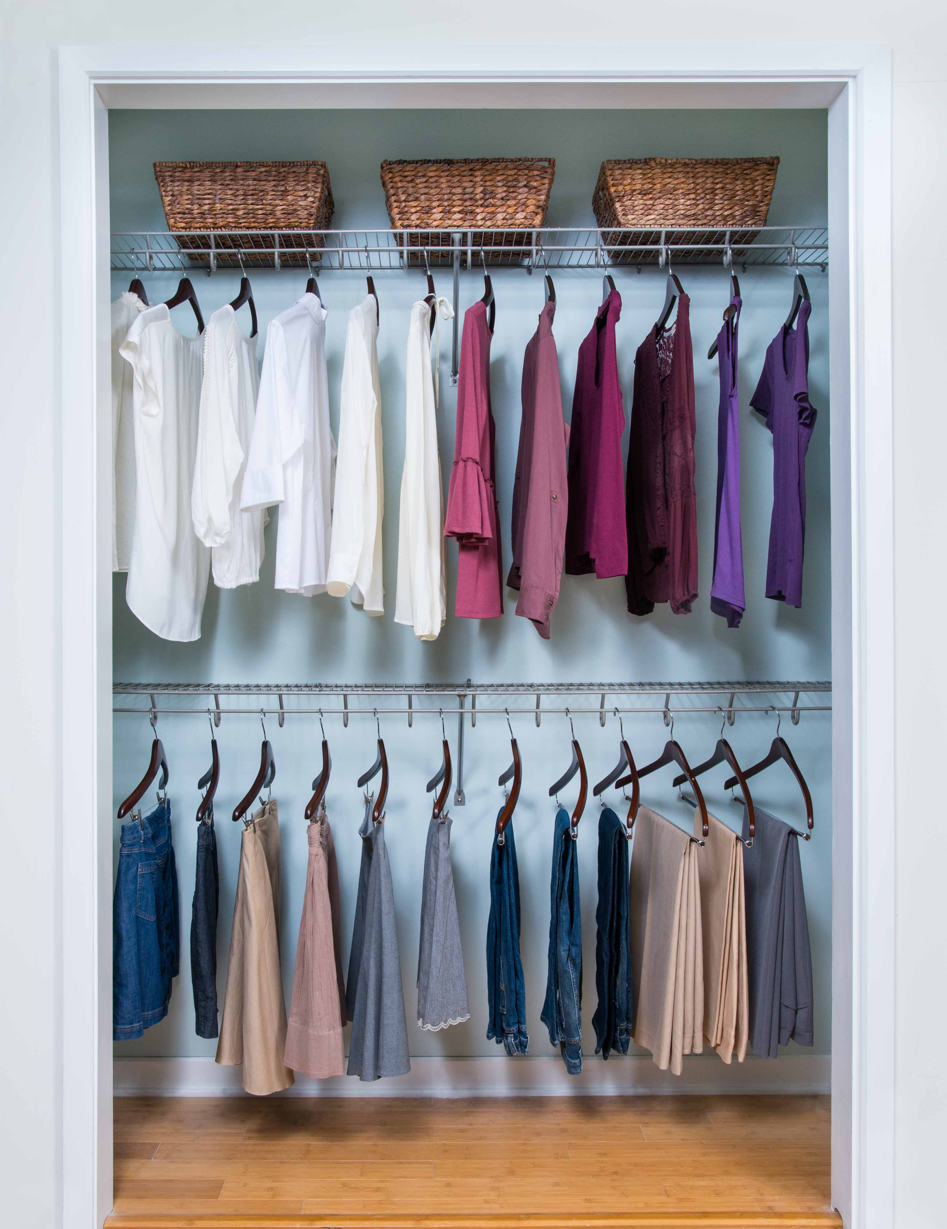 Lifetime Reach-in Closet in Nickel with women's shirts, bottoms, and 3 woven baskets. 