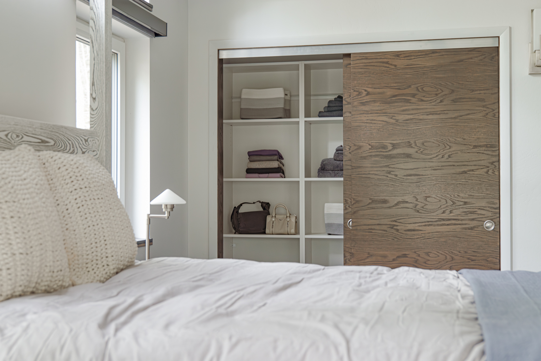 Mariposa Meadows Compound Interior with picture of closet, bed, and neutral accents.