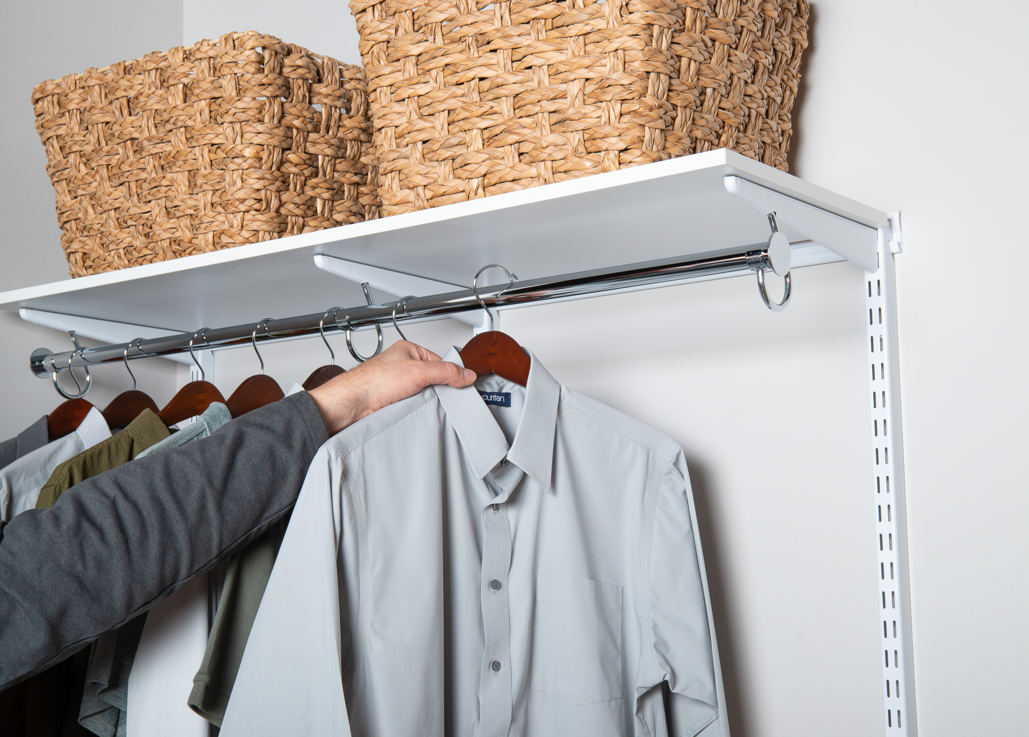 Mens fR Reach-in 6 with baskets, hanging shirts, and man hanging shirt.