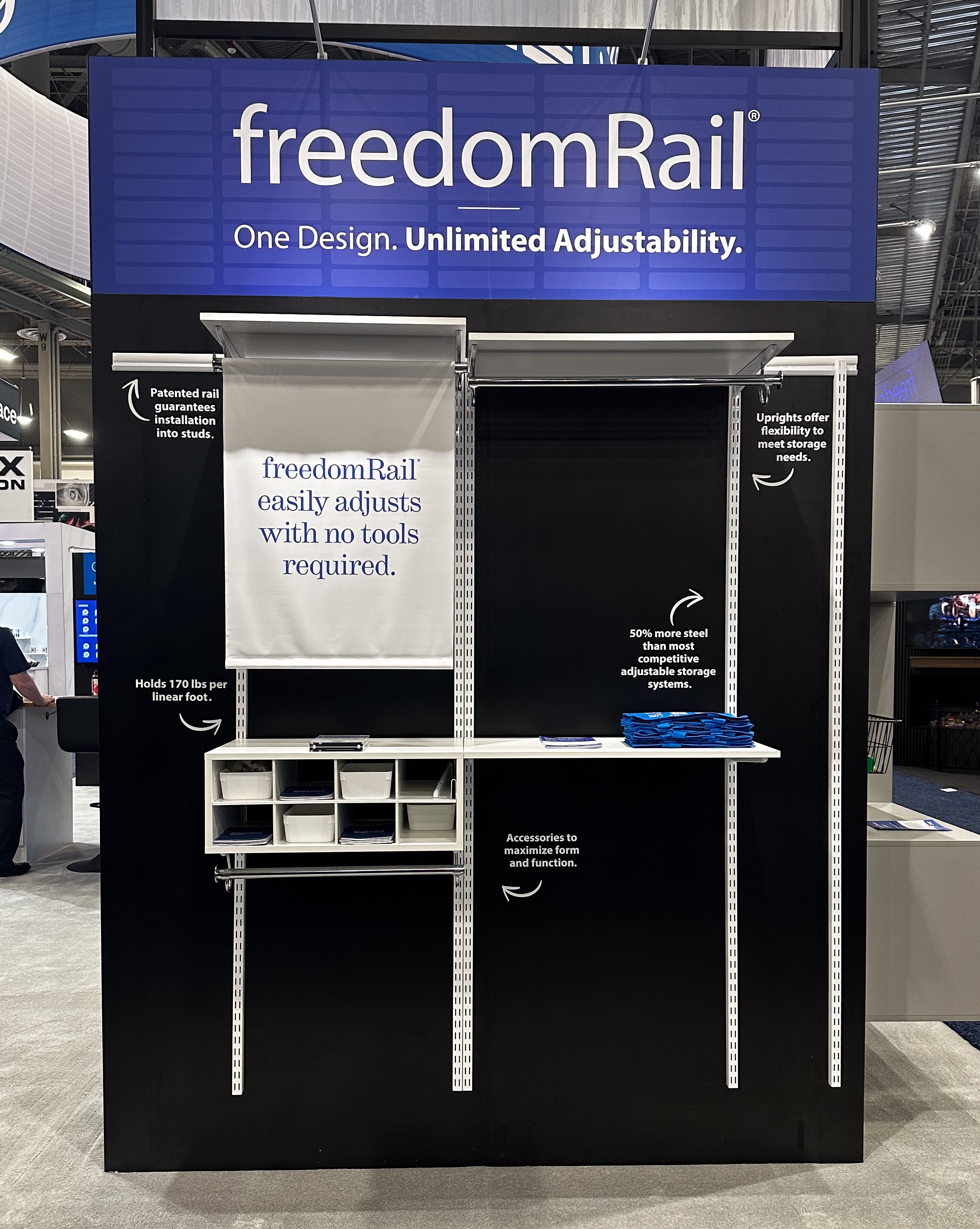 Organized Living Booth freedomRail Demo Wall with call out stickers and large sign.