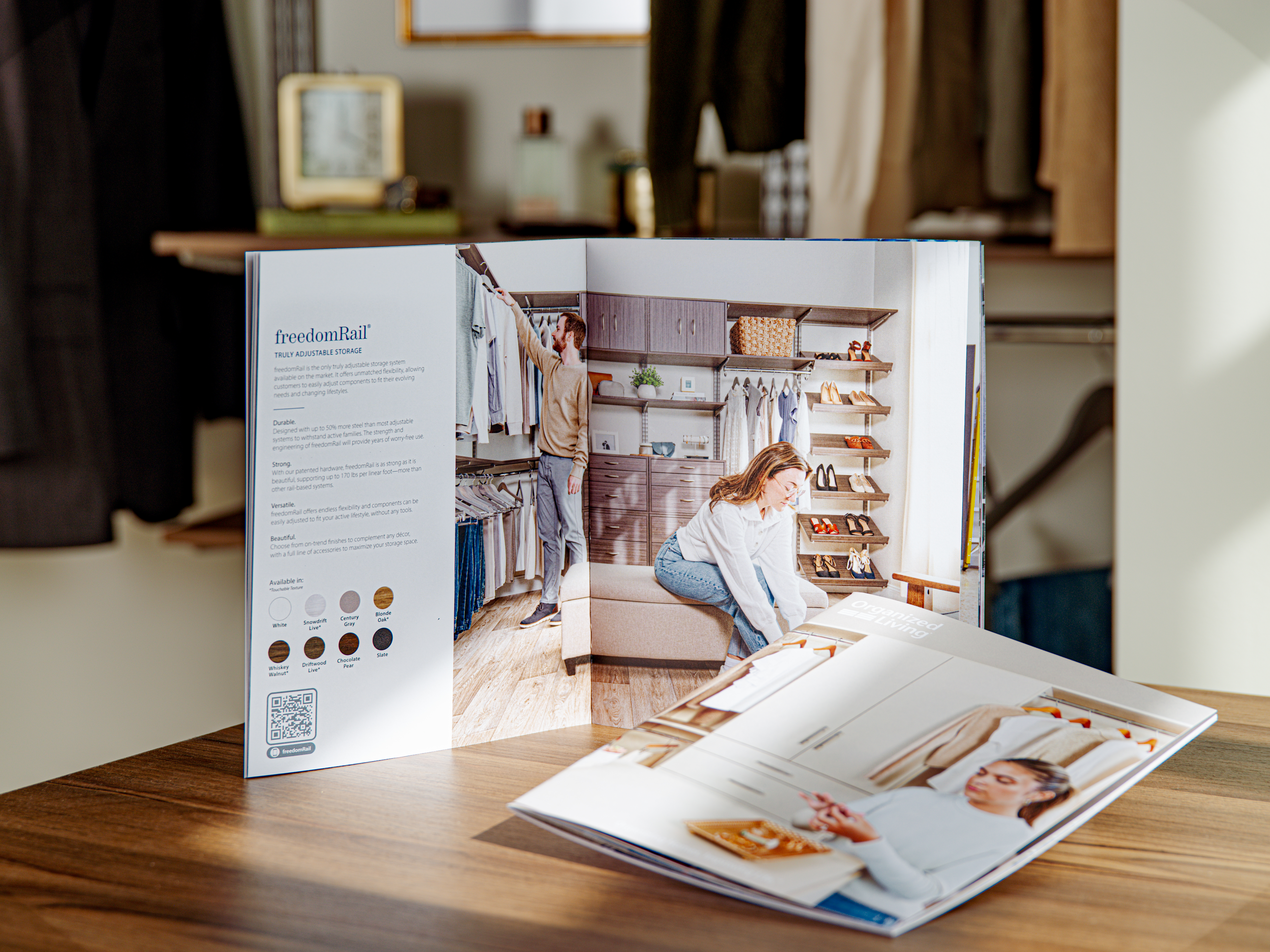 with 2 brochures, one propped vertically and one laying down on counter with closet neutrally propped blurred out in background.