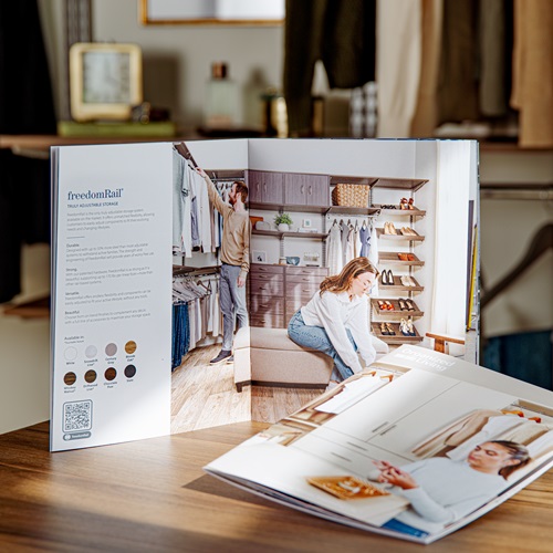 with 2 brochures, one propped vertically and one laying down on counter with closet neutrally propped blurred out in background.