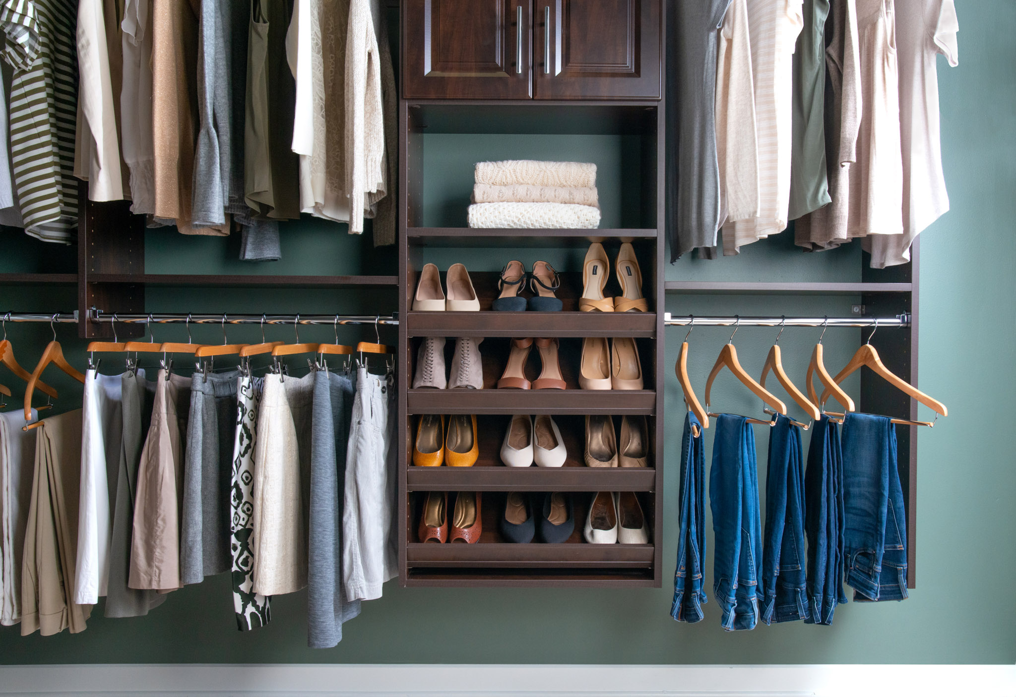 Select Walk-in Closet in Chocolate Pear with women's shirts, skirts, jeans, and shoes.