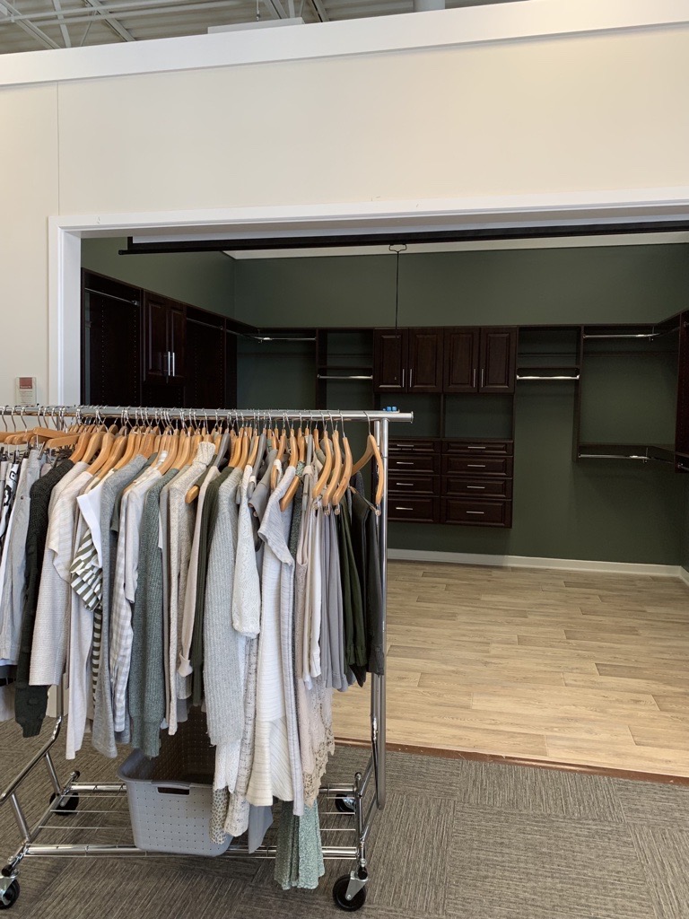 Select Walk-in Closet Propping with clothes rack and empty closet.