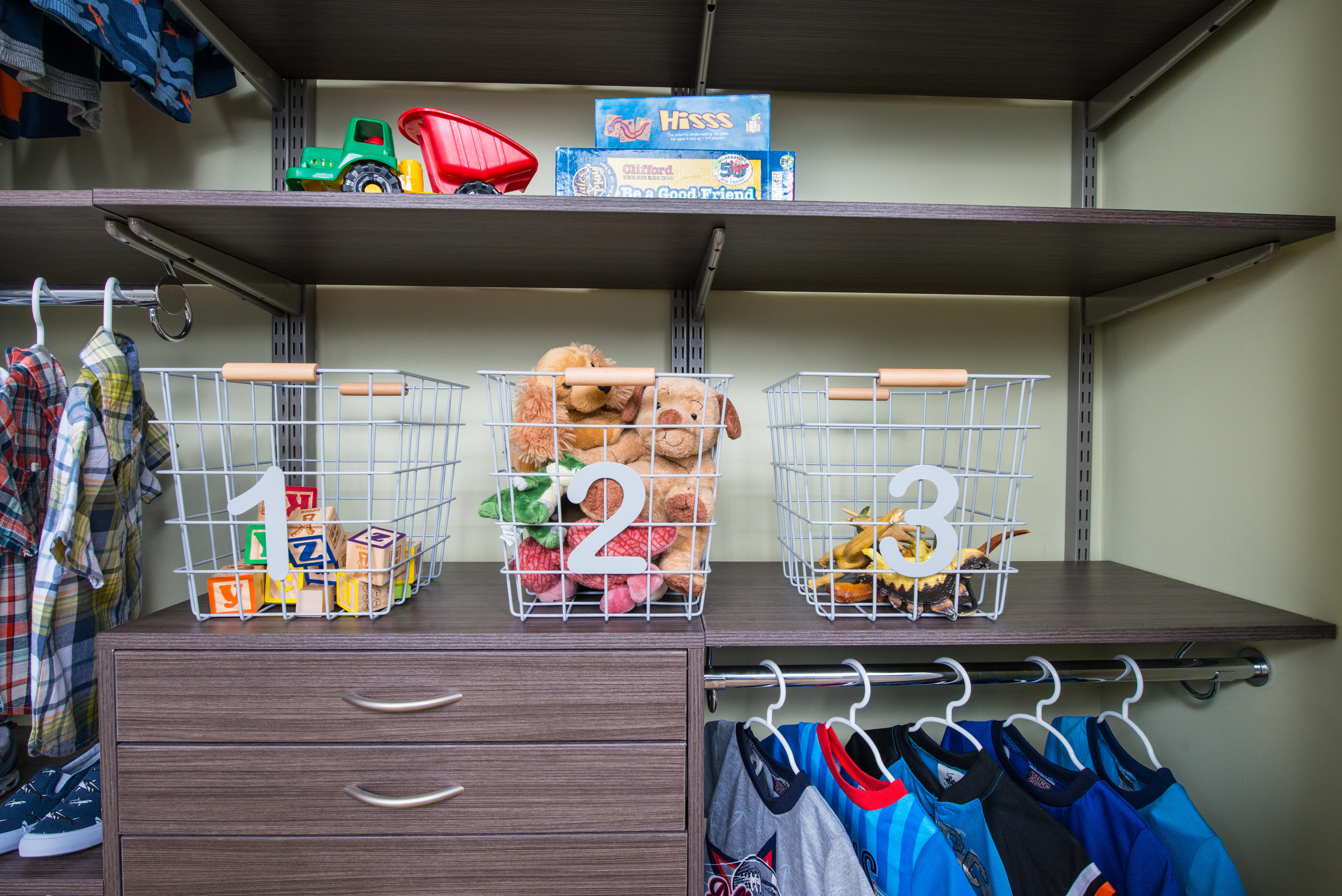 freedomRail Reach-in closet in Driftwood Live with child's clothes and toys.