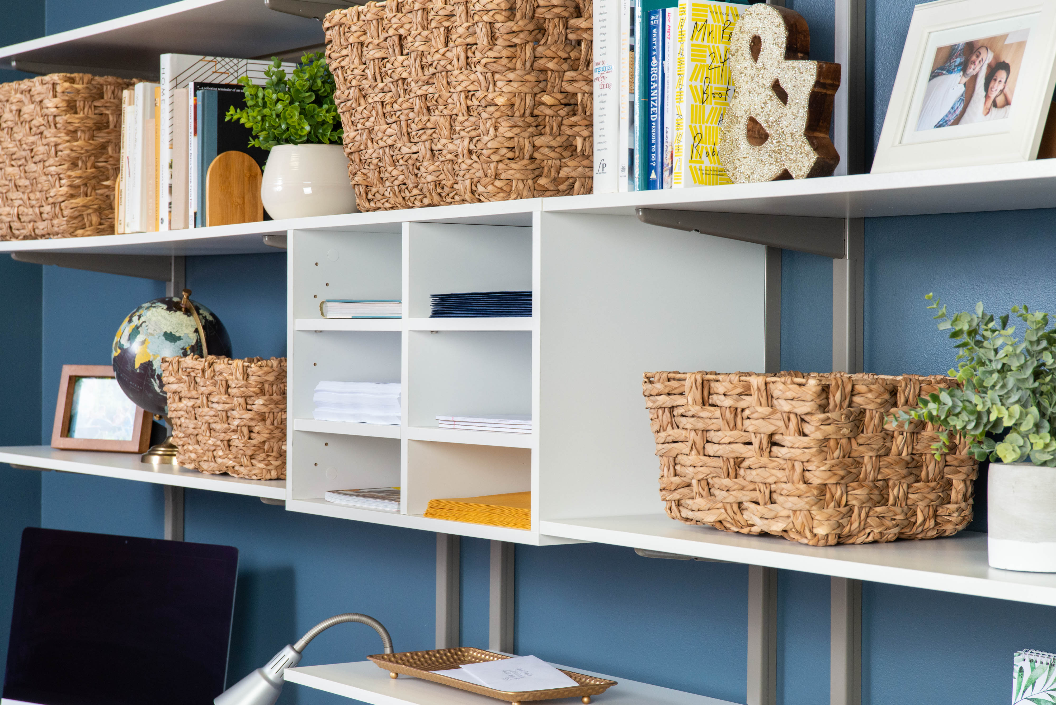 freedomRail White Dual Desk Office with close up of wicker baskets, 6 shelf cubby, office décor, and blue background. 