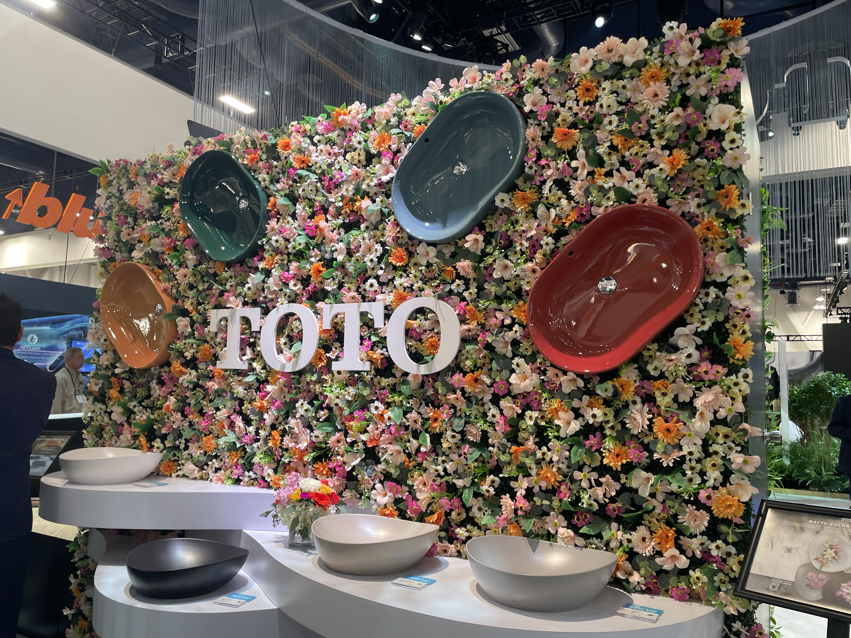 TOTO Sink Display at IBS 2025 with floral wall and big text 