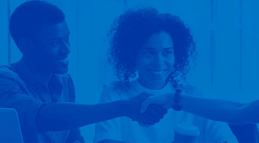 2 people and one of them is shaking hands with another. There is a blue overlay on the entire image.