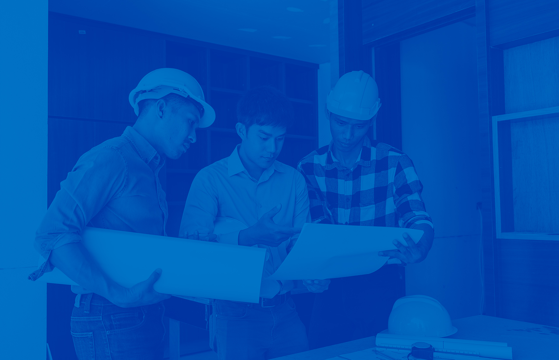 Blue overlay of 3 industry professionals holding plans for a home closet.