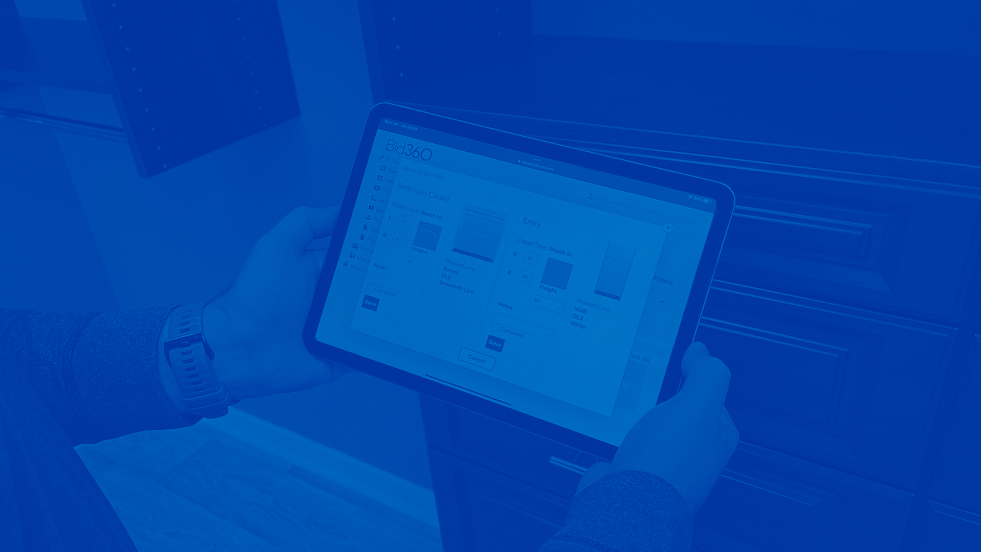 Bid360 Person Holding IPad Dark Blue Overlay