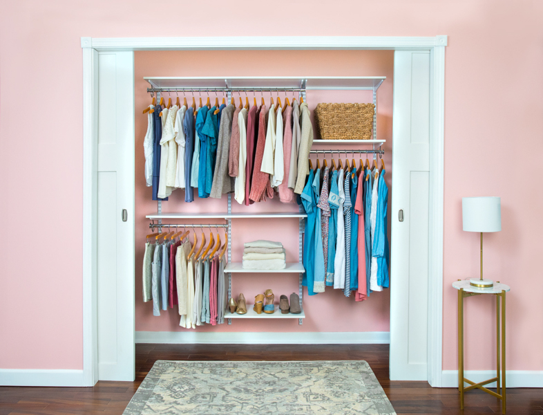 freedomRail Reach-in Closet with women's clothes and pink background.