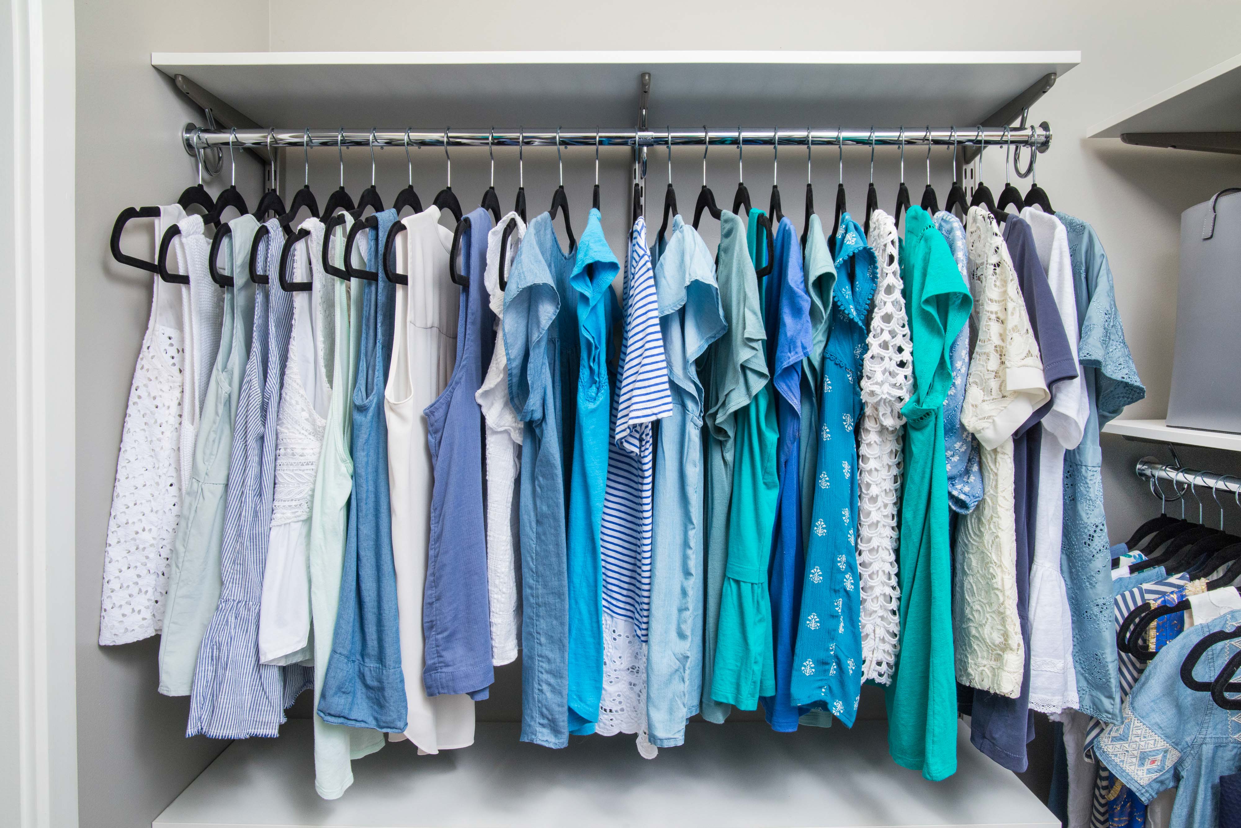 freedomRail Closet in White with women's tops and neutral background.