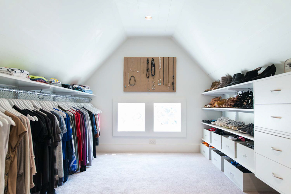 freedomRail Primary Bedroom Walk-in Closet in White photograph with clothes and accessories.