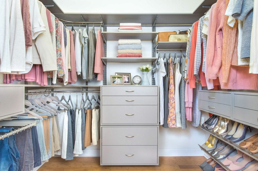 freedomRail Primary Bedroom Walk-in Closet in Century Gray with clothes and white walls.