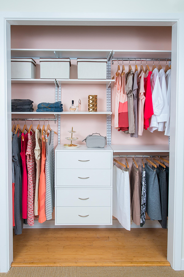 freedomRail reach-in closet in White with women's clothing, accessories, and storage bins.