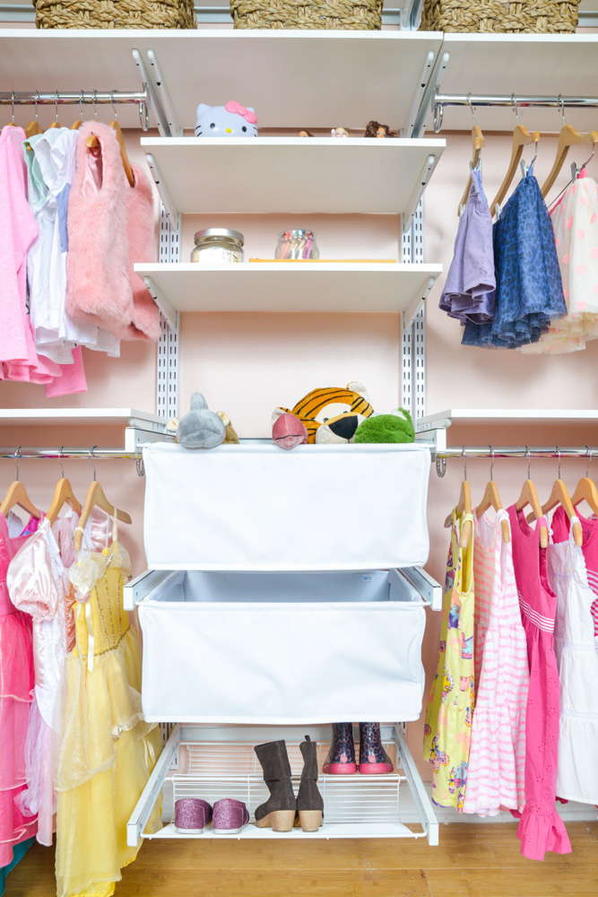 freedomRail Reach-in Closet in White with stuffed animals and pink walls.