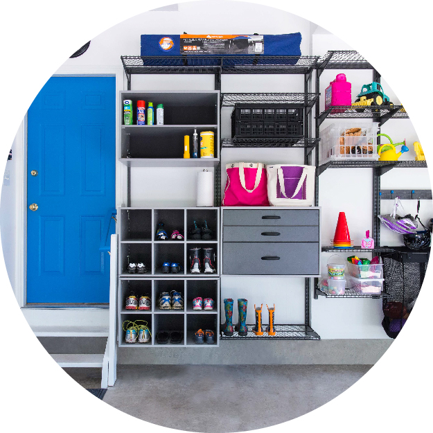 Circle cropped image of freedomRail Garage propped with garage items. There is a blue door to the left of the storage system.