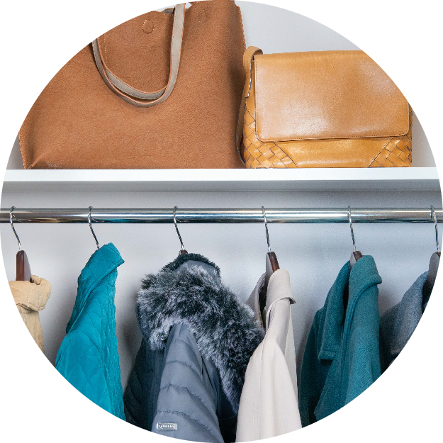 Entry area of home space. There is an activity organizer and propped on this organization unit is a backpack, umbrella, jacket and other drop-off items.