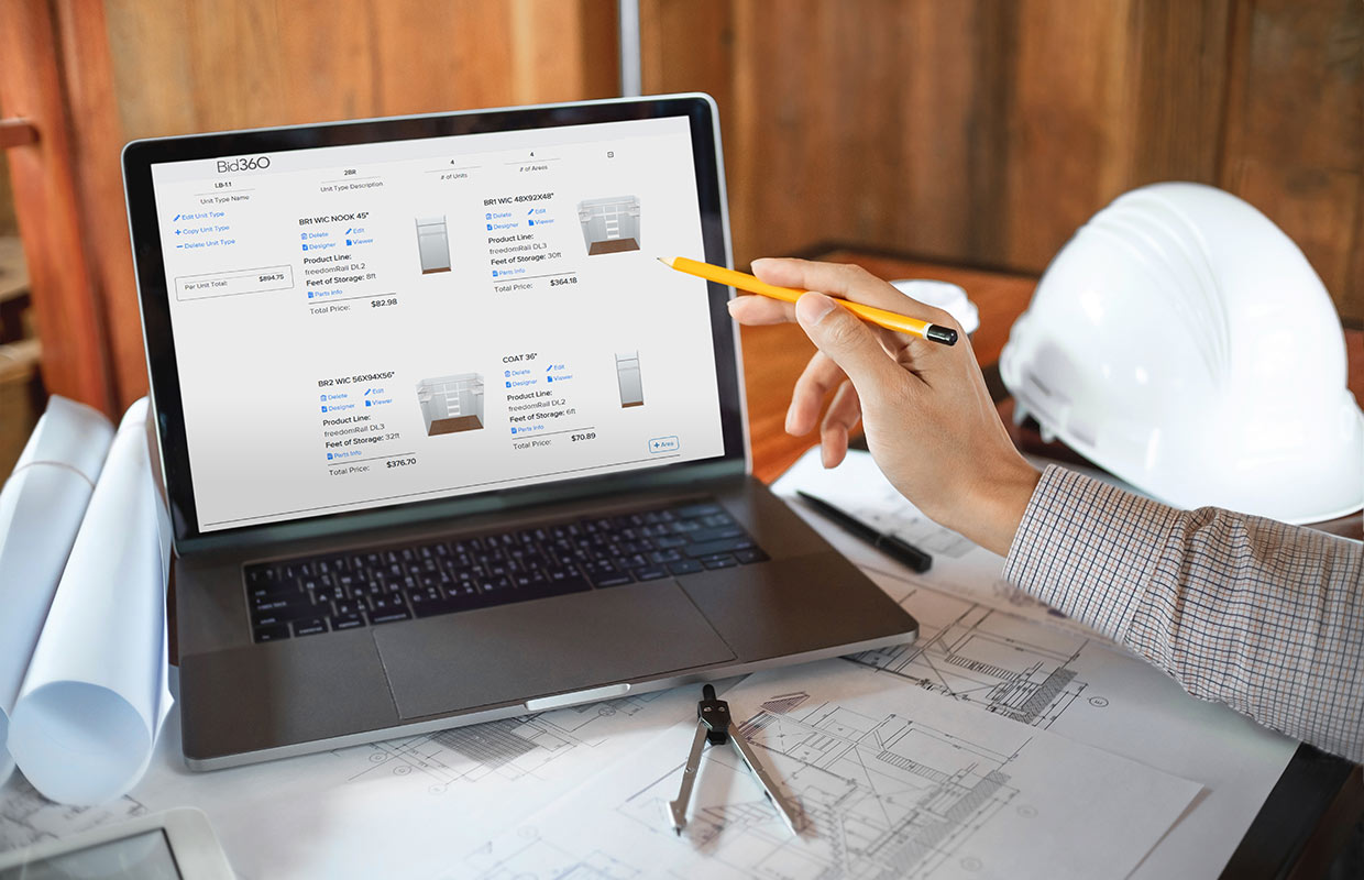 Person pointing to laptop screen with pencil.