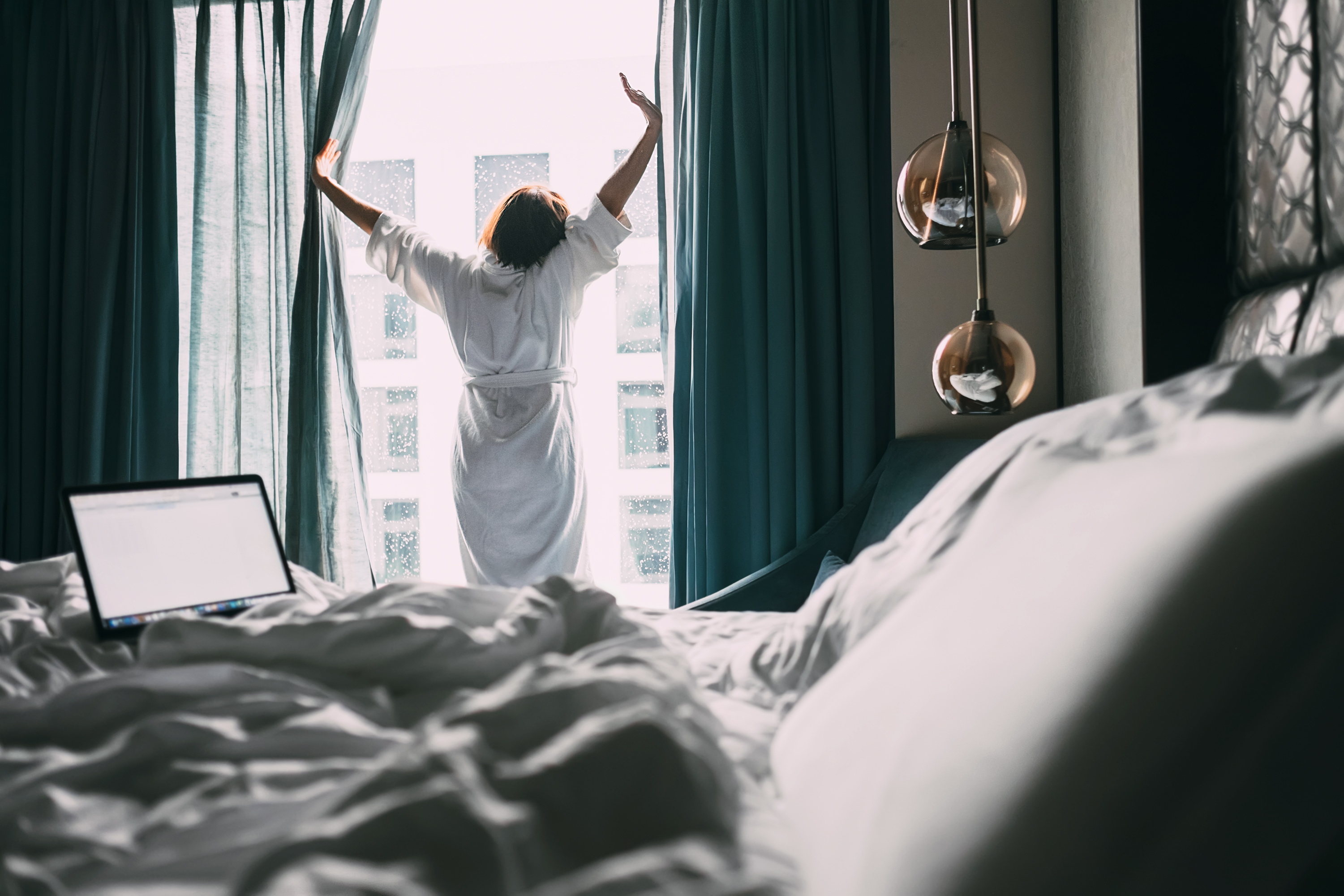 Woman stretching inside of hotel room.