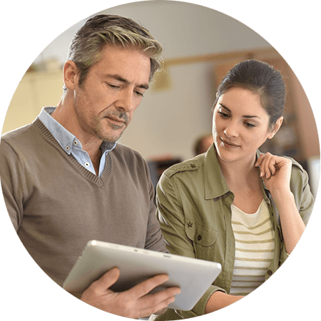 Two professionals reading a tablet