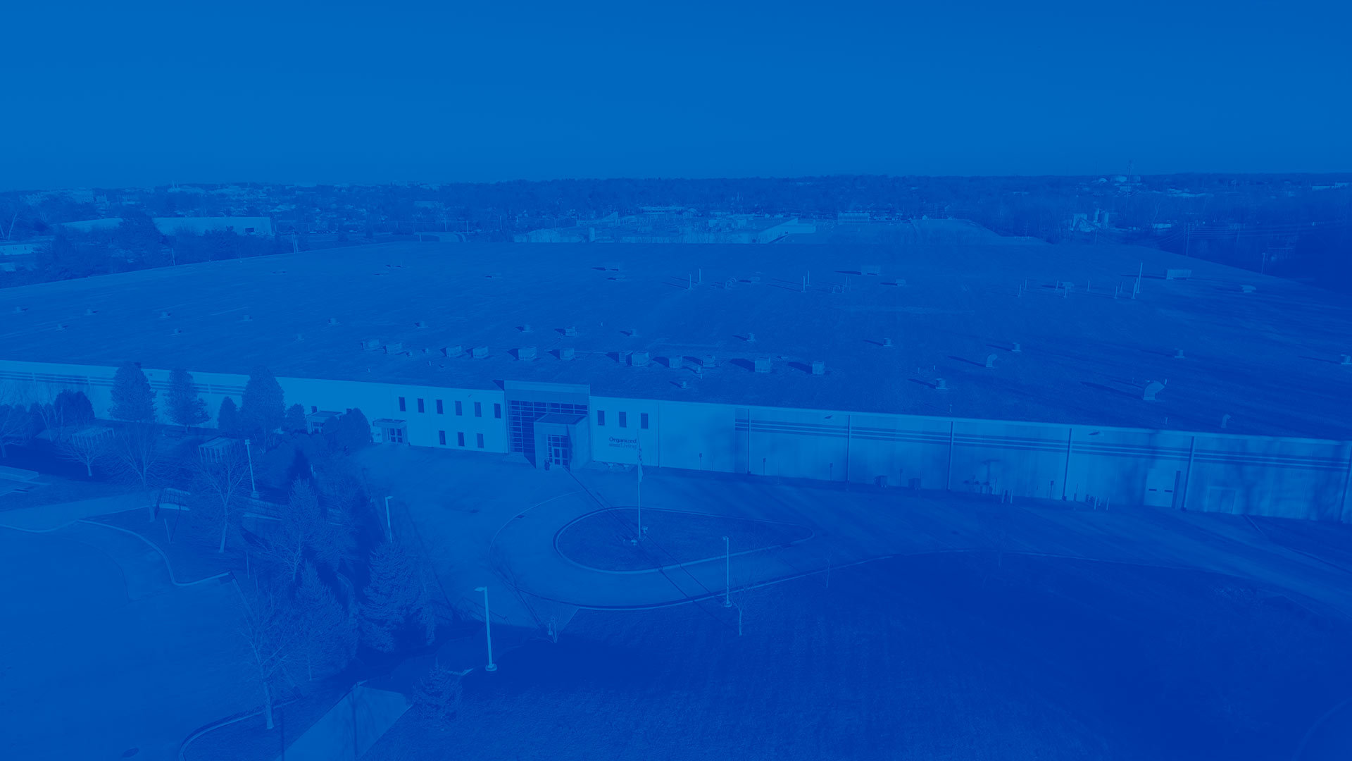 Organized Living Factory in blue overlay