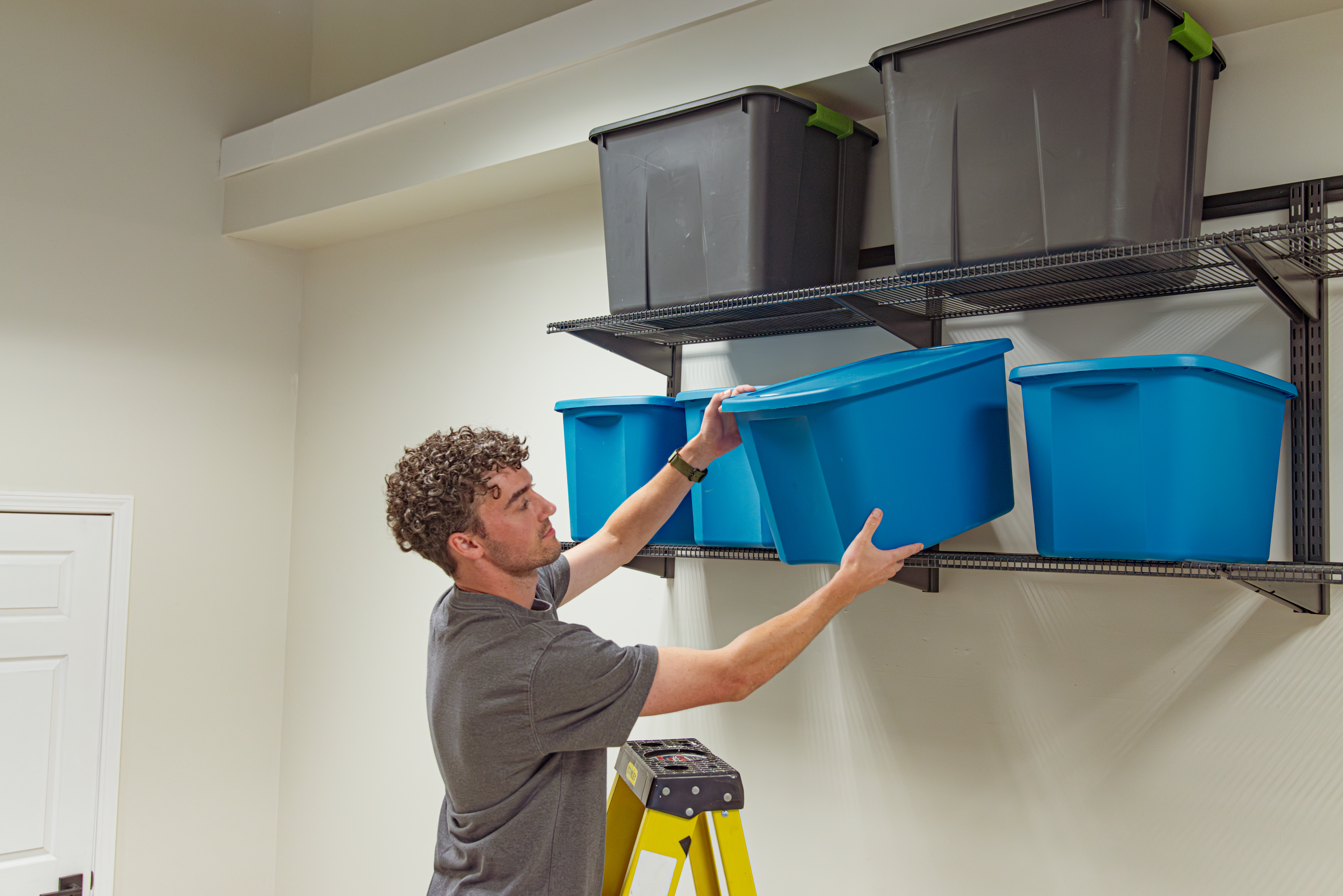 freedomRail Garage in Granite Gray exercise equipment and shelves.