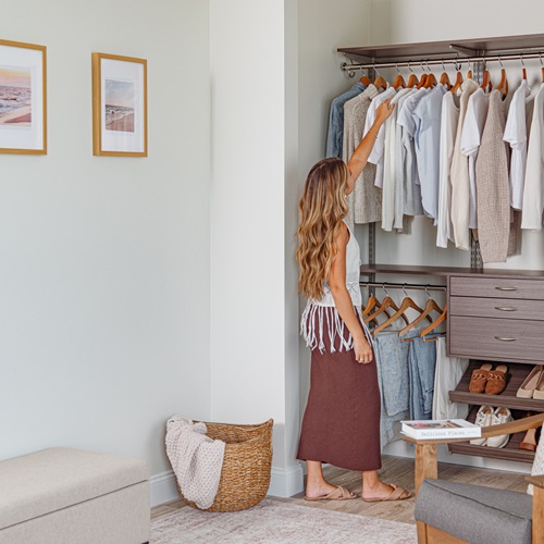 woman walking up to freedomRail reach-in closet.