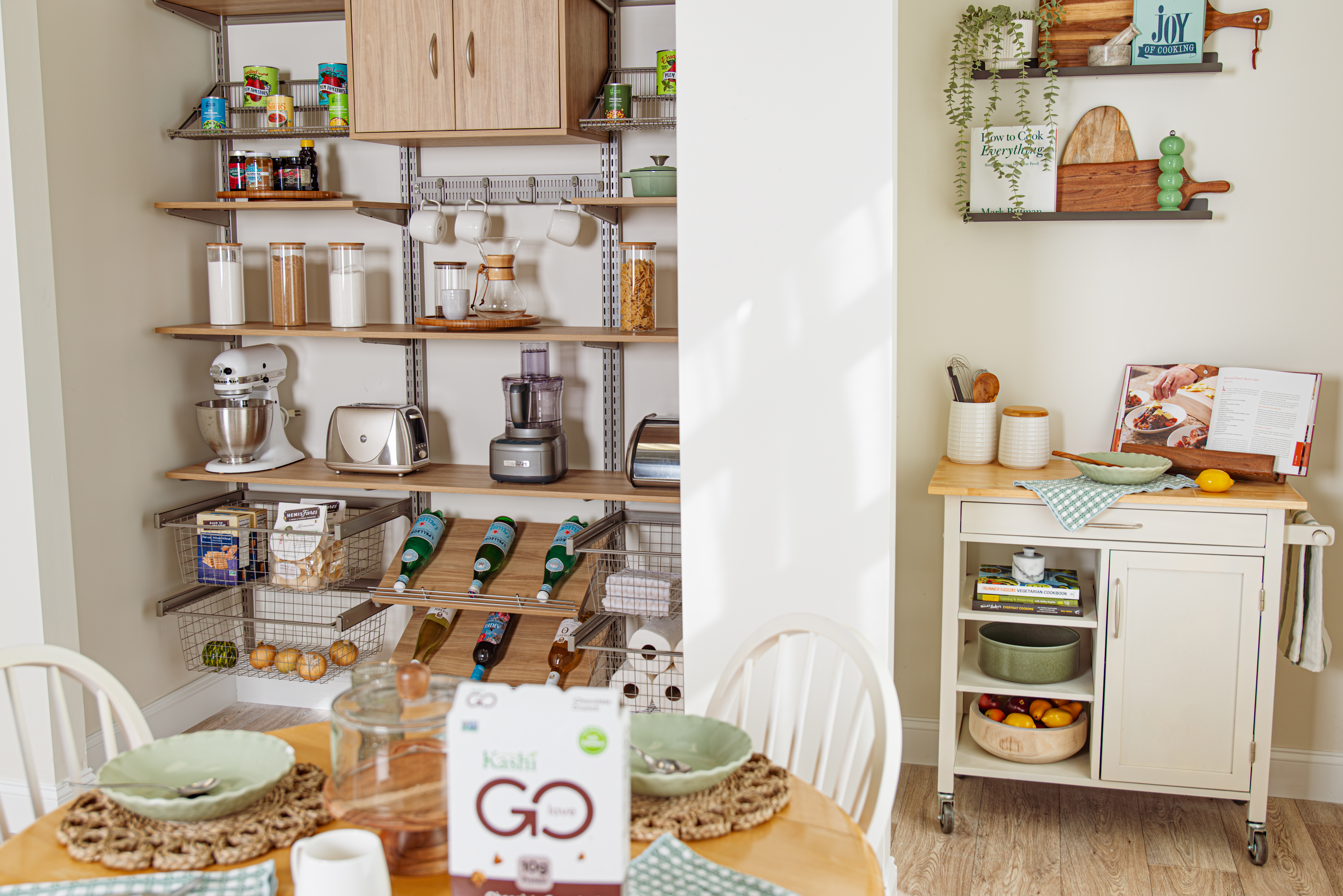 Circle cropped image of Blonde Oak freedomRail Pantry Closet by Organized Living propped with pantry food and appliances.