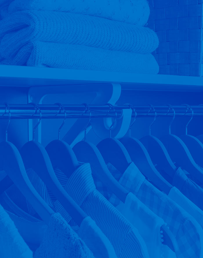 VUE closet with clothes and sweaters on the shelf
