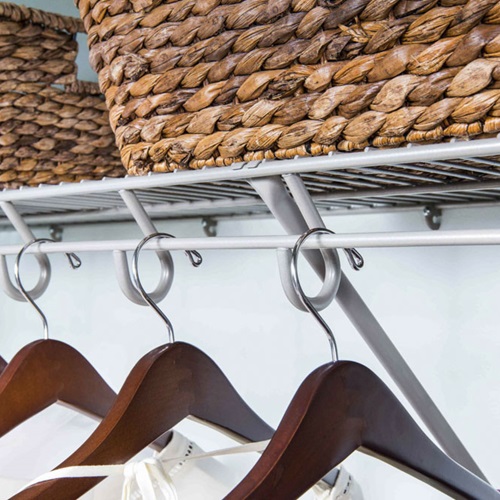 Lifetime Nickel in reach-in closet with a neutral background with hangers and baskets.